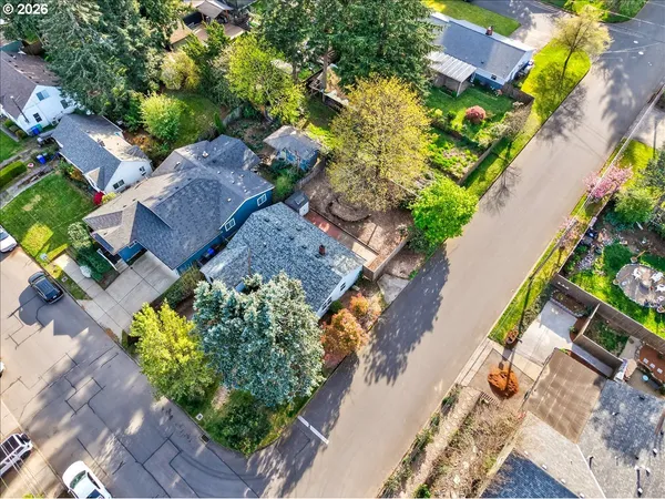 an aerial view of a house with a yard and a garden