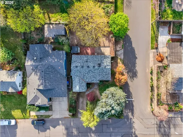 an aerial view of a house with a yard and garden