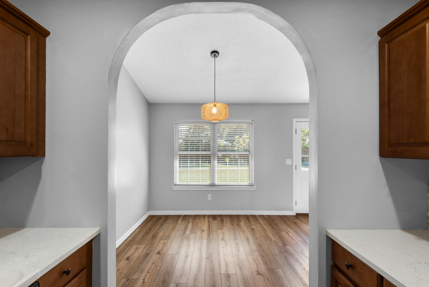 4022 13th Street Niceville, FL 32578 - Photo 11 of 37 a view of an empty room with wooden floor and a window