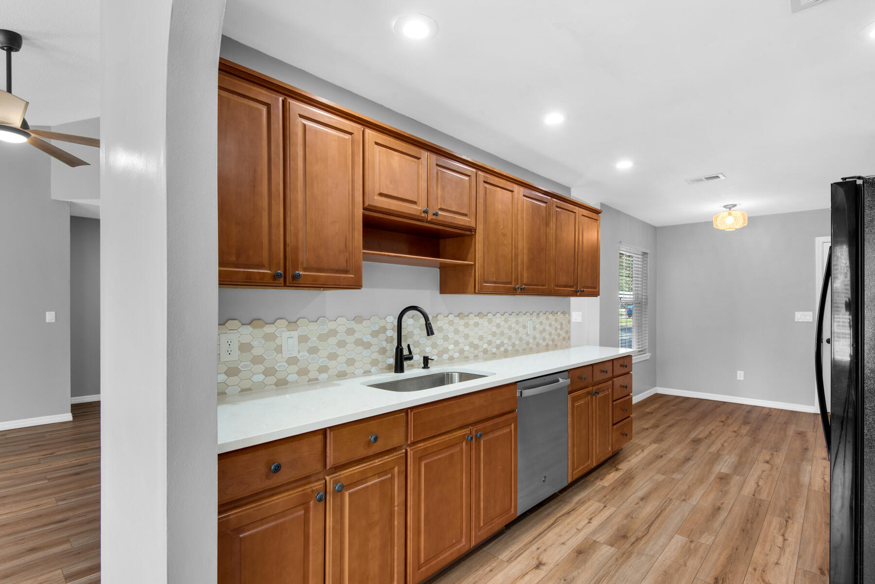 4022 13th Street Niceville, FL 32578 - Photo 12 of 37 a kitchen with stainless steel appliances granite countertop a sink stove and refrigerator