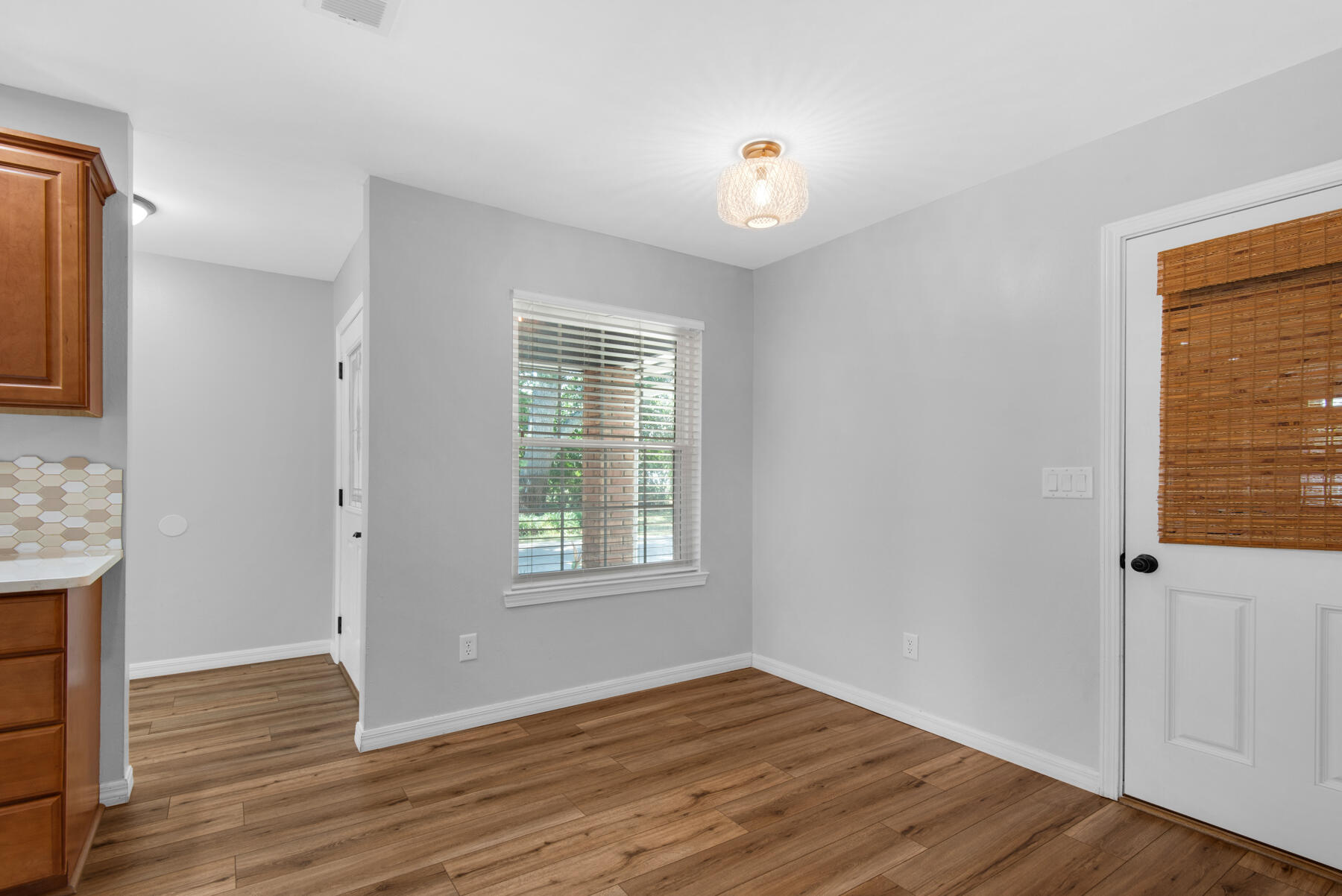 4022 13th Street Niceville, FL 32578 - Photo 17 of 37 an empty room with wooden floor and windows