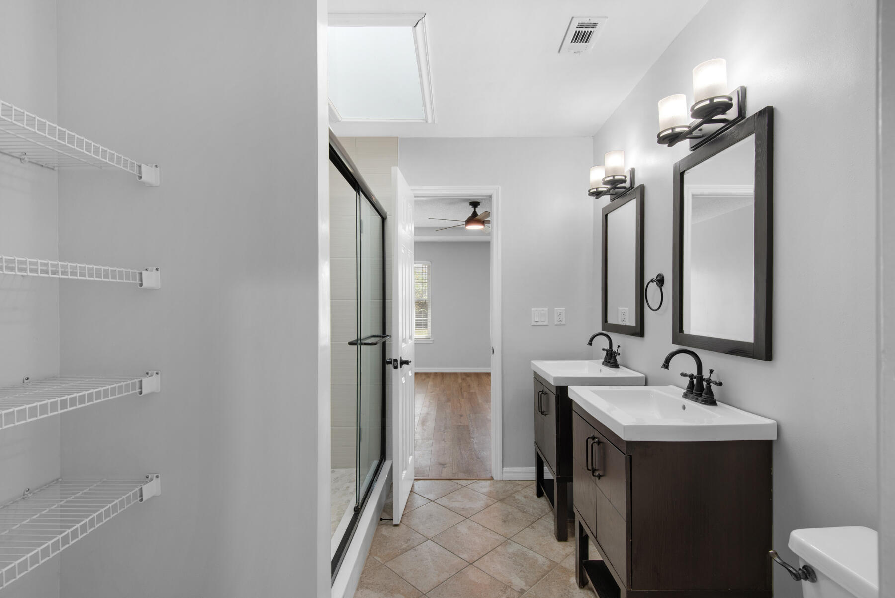 4022 13th Street Niceville, FL 32578 - Photo 20 of 37 a bathroom with a double vanity sink and mirror