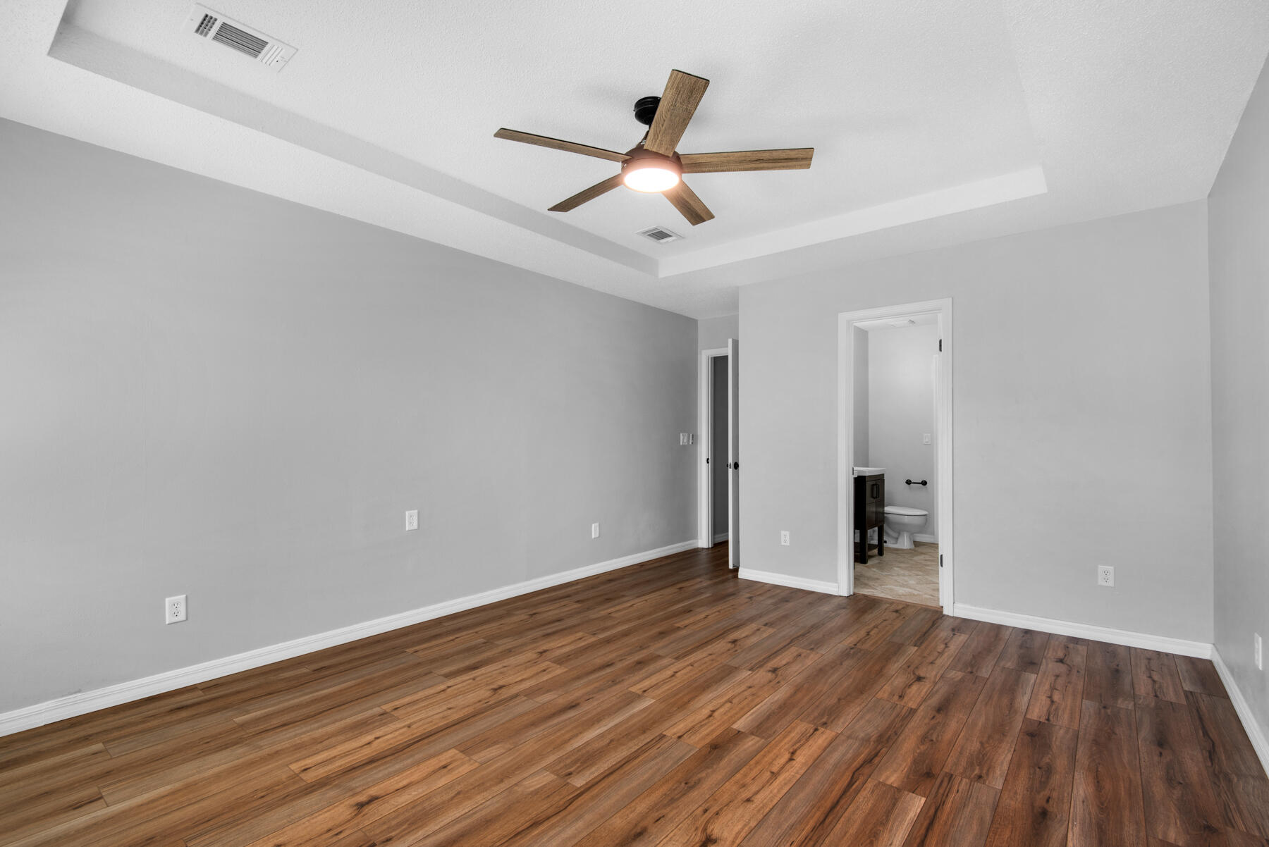 4022 13th Street Niceville, FL 32578 - Photo 24 of 37 an empty room with wooden floor and a ceiling fan