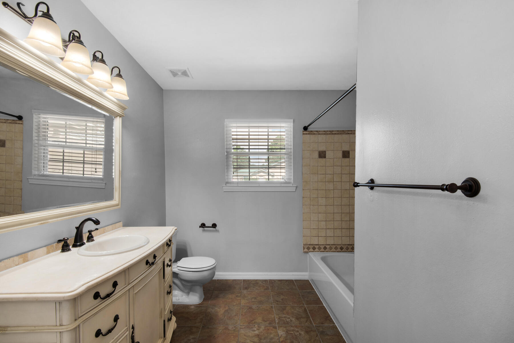4022 13th Street Niceville, FL 32578 - Photo 26 of 37 a bathroom with a granite countertop sink toilet a shower and a bathtub