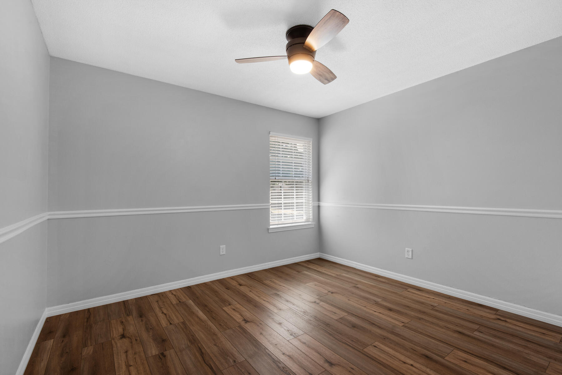4022 13th Street Niceville, FL 32578 - Photo 32 of 37 a view of empty room with wooden floor and fan