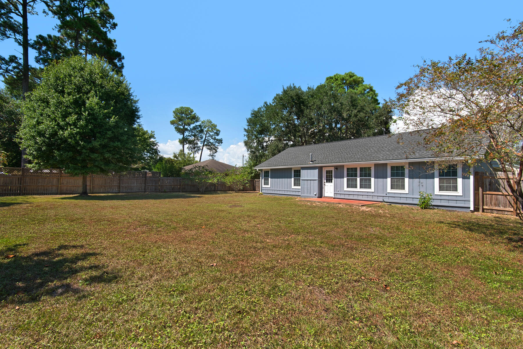 4022 13th Street Niceville, FL 32578 - Photo 34 of 37 a front view of house with yard and trees in the background