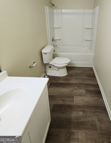 335 Freeman Circle Villa Rica, GA 30180 - Photo 7 of 12 a bathroom with a toilet and a bathtub