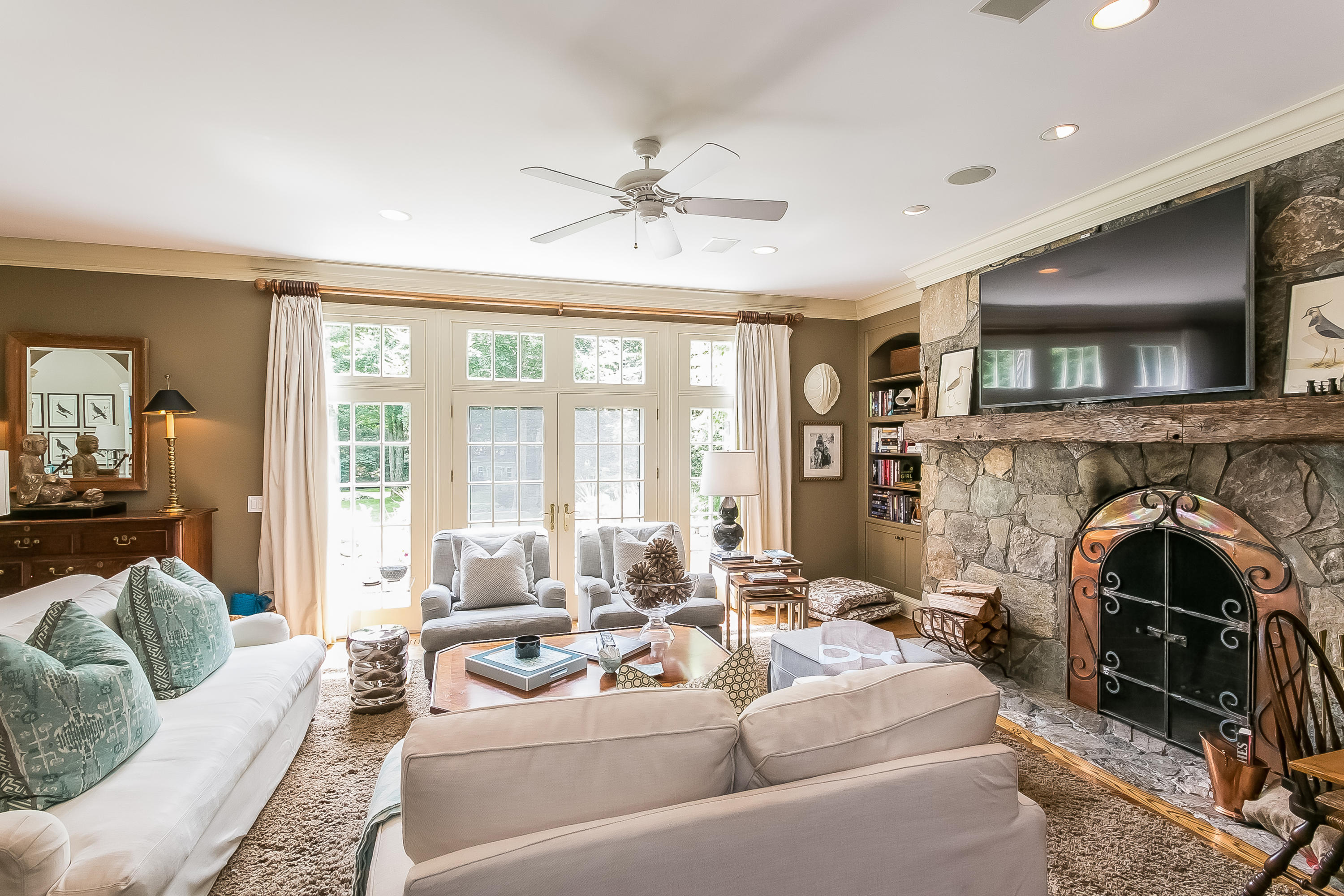 50 Deepwood Road Darien, CT 06820 - Photo 23 of 54 a living room with furniture a fireplace and a flat screen tv