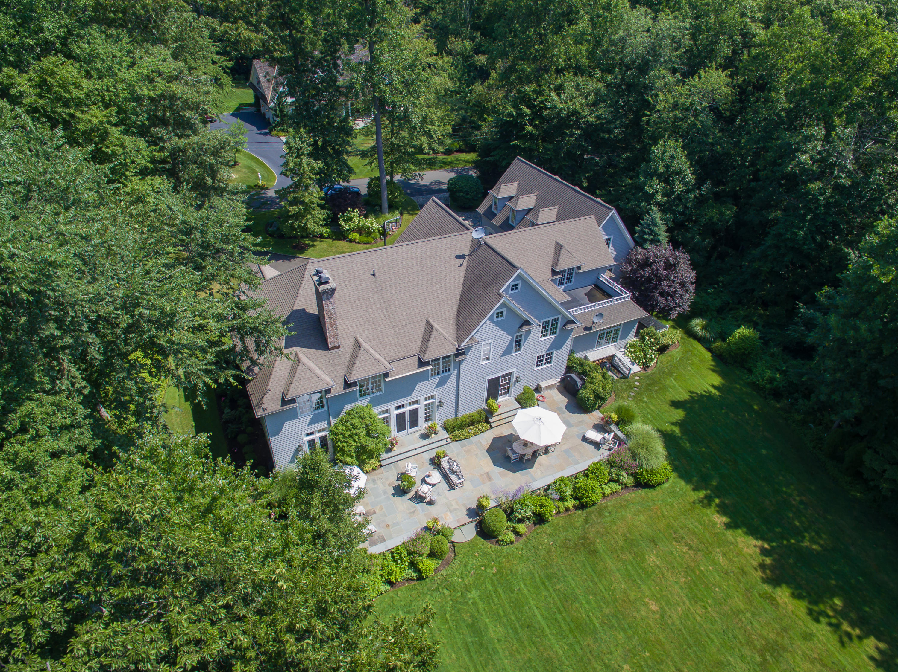 50 Deepwood Road Darien, CT 06820 - Photo 4 of 54 an aerial view of a house with a yard and large trees