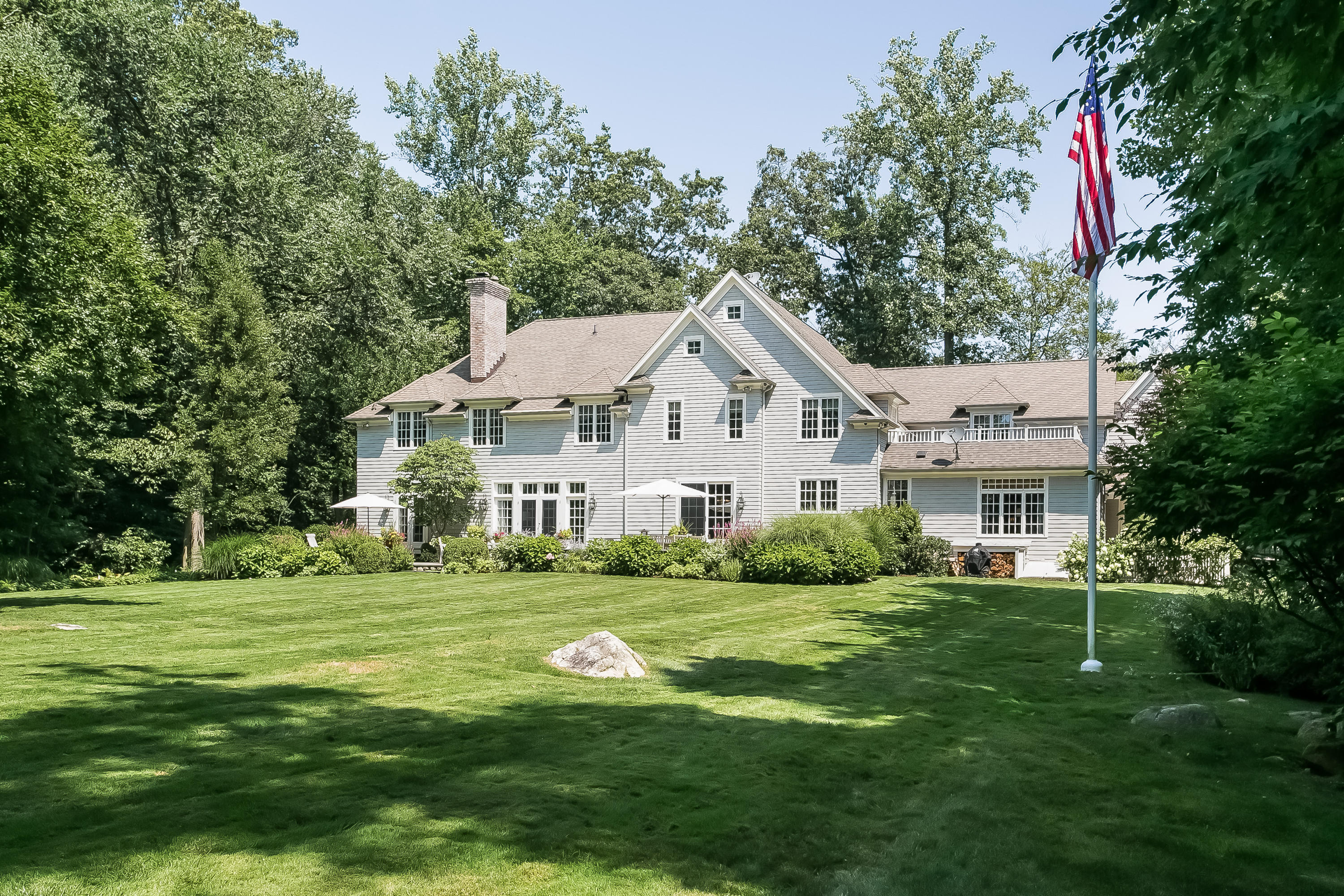 50 Deepwood Road Darien, CT 06820 - Photo 47 of 54 a view of a white house with a yard and sitting area