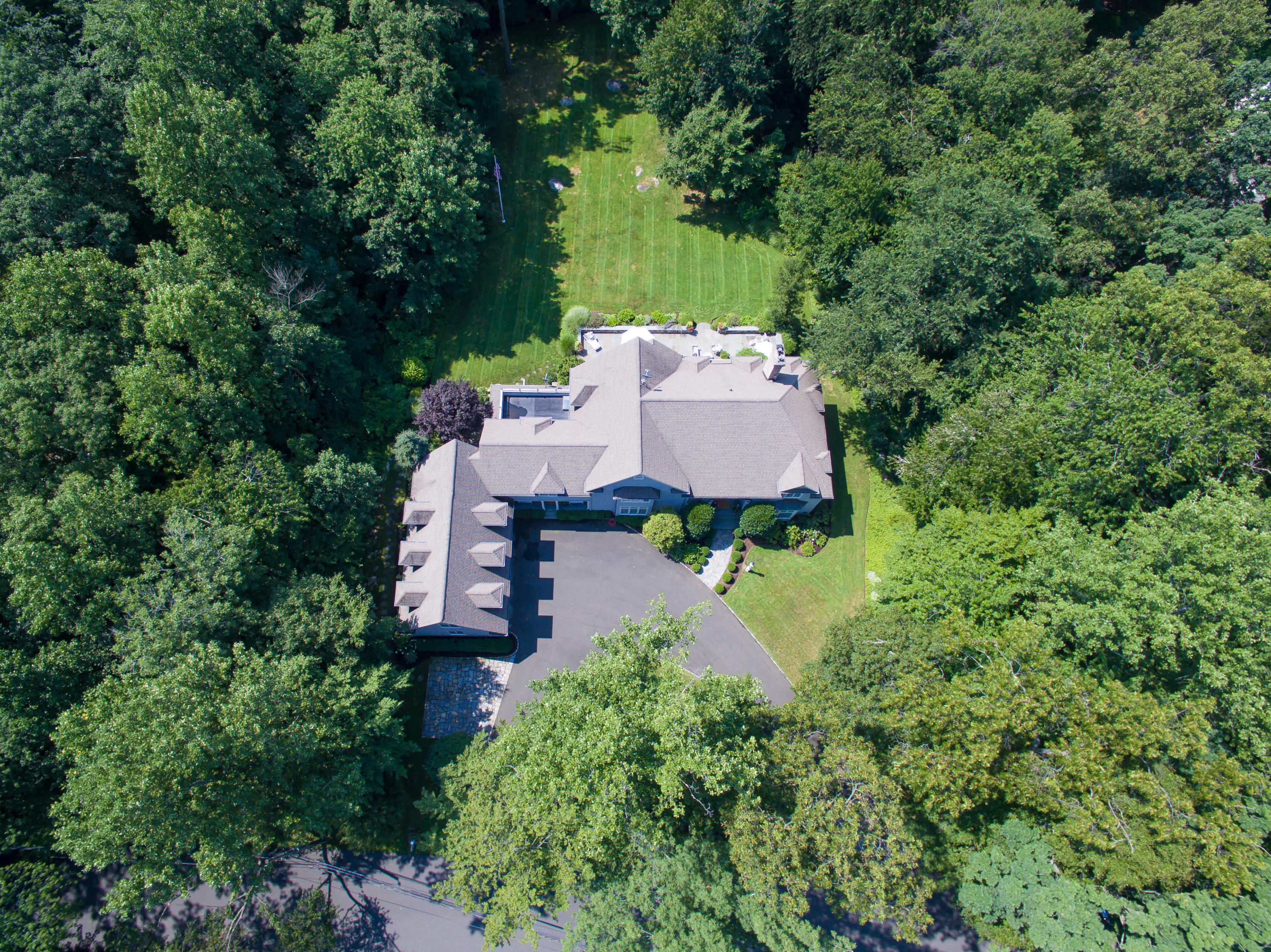 50 Deepwood Road Darien, CT 06820 - Photo 50 of 54 an aerial view of a house with table and chairs