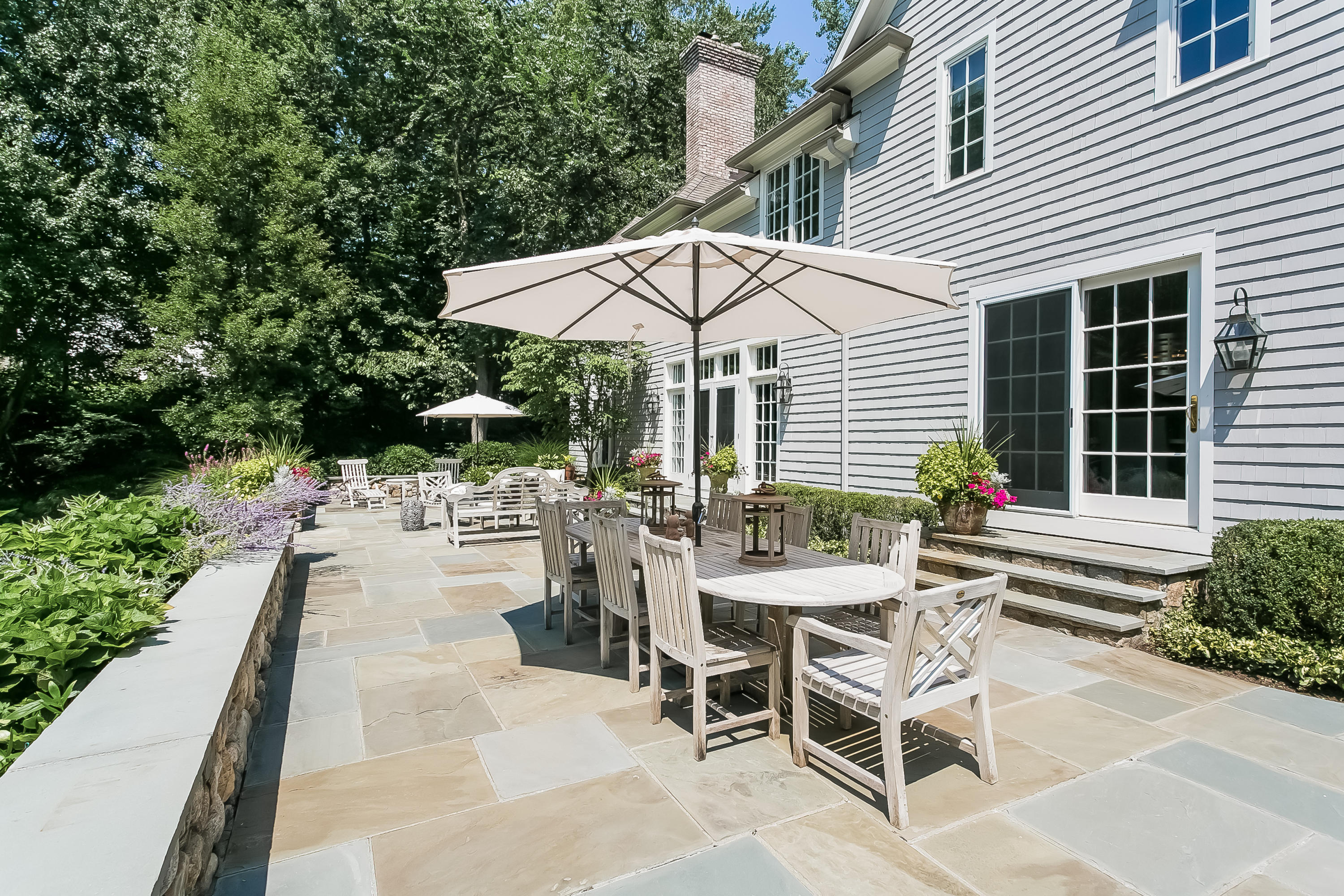 50 Deepwood Road Darien, CT 06820 - Photo 6 of 54 a view of a patio with a table and chairs under an umbrella