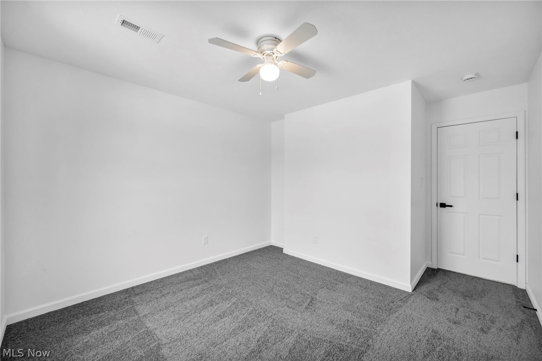 3670 Pennington Road Cleveland, OH 44120 - Photo 24 of 28 Spare room with dark colored carpet and ceiling fan
