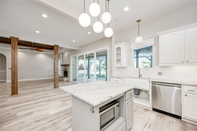 a kitchen with a stove and a wooden floor