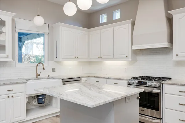 a kitchen with a sink cabinets and stainless steel appliances