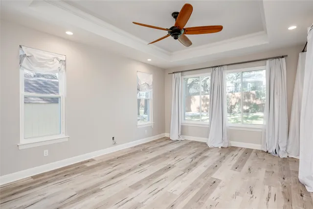 a view of a livingroom with a ceiling fan and a large window