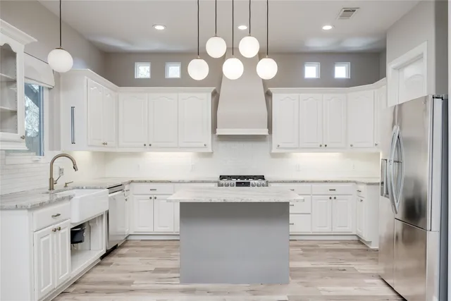 a kitchen with a sink stainless steel appliances and cabinets