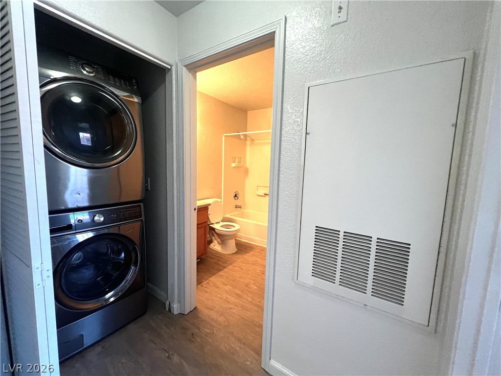 4730 East Craig Road, Unit 2104 Las Vegas, NV 89115 - Photo 8 of 20 A dedicated laundry area features a convenient stacked washer and dryer, adjacent to a well-appointed bathroom.