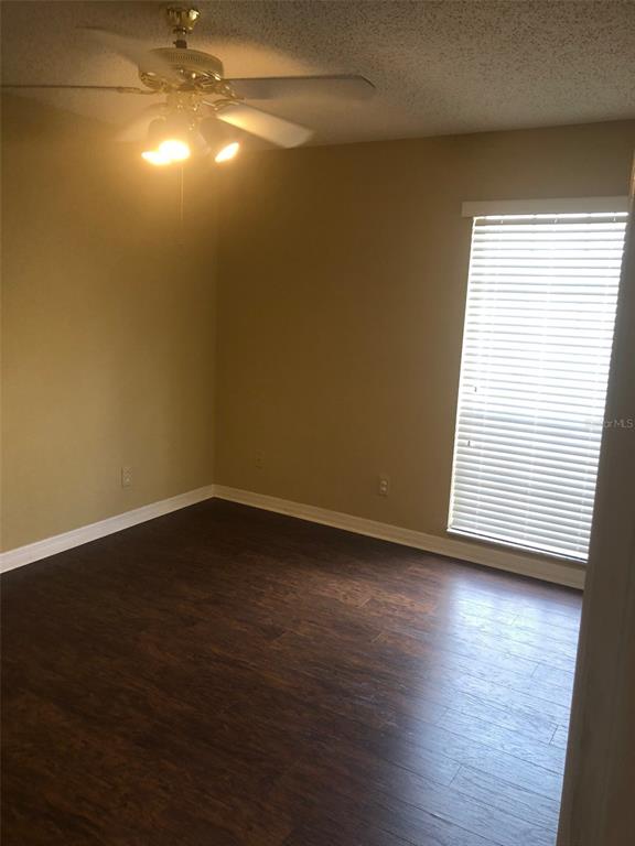 315 Wymore Road, Unit 207 Altamonte Springs, FL 32714 - Photo 12 of 21 a view of an empty room with wooden floor and a window