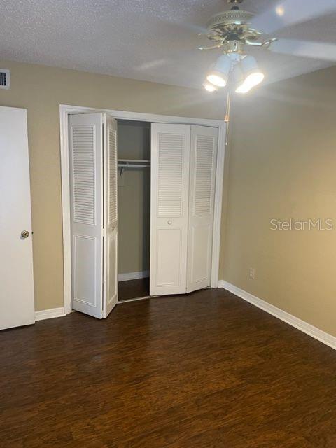 315 Wymore Road, Unit 207 Altamonte Springs, FL 32714 - Photo 13 of 21 a view of an empty room with wooden floor and chandelier fan