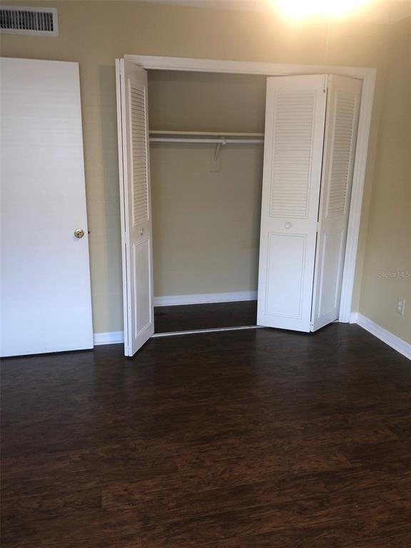 315 Wymore Road, Unit 207 Altamonte Springs, FL 32714 - Photo 14 of 21 a view of an empty room with wooden floor and closet