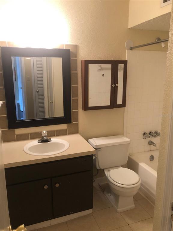 315 Wymore Road, Unit 207 Altamonte Springs, FL 32714 - Photo 16 of 21 a bathroom with a toilet a sink and mirror