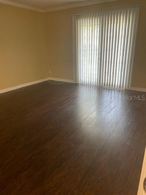 315 Wymore Road, Unit 207 Altamonte Springs, FL 32714 - Photo 3 of 21 an empty room with wooden floor and windows
