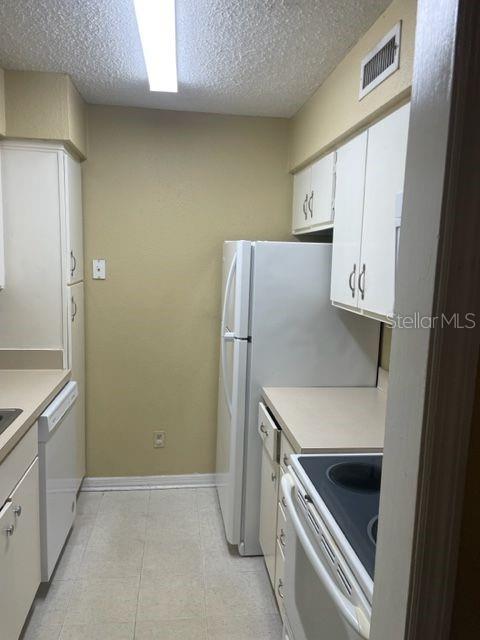 315 Wymore Road, Unit 207 Altamonte Springs, FL 32714 - Photo 6 of 21 a kitchen with a refrigerator and a sink