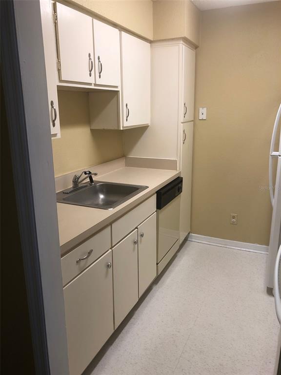315 Wymore Road, Unit 207 Altamonte Springs, FL 32714 - Photo 8 of 21 a kitchen with a sink and cabinets