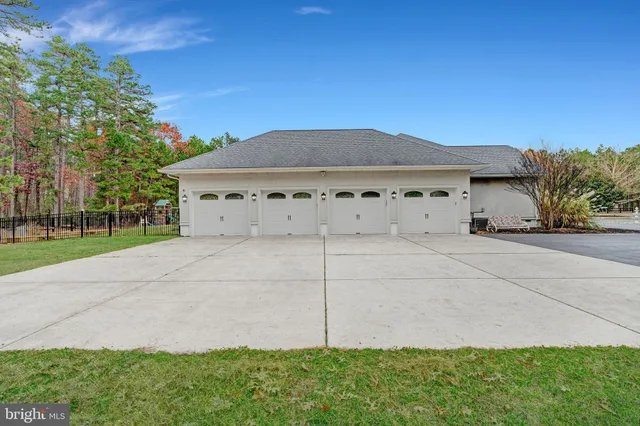 a view of a green field with trees in the background