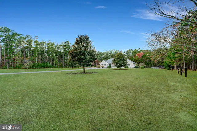 a large bedroom with a large bed and a view of living room