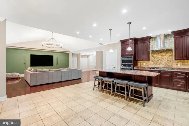a kitchen with kitchen island a sink dining table and chairs