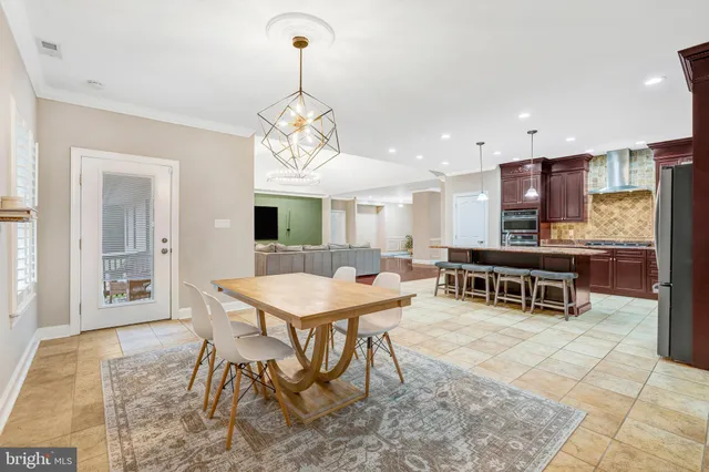 a view of a hallway with wooden floor and a living room