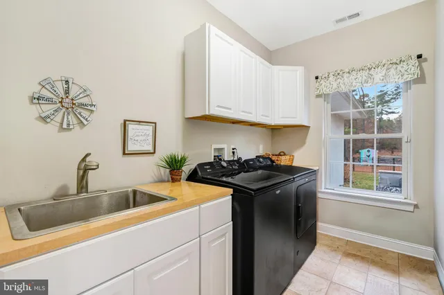 a spacious bathroom with double vanity and a bathtub