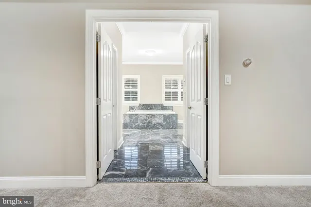 a spacious bedroom with a bed and a window