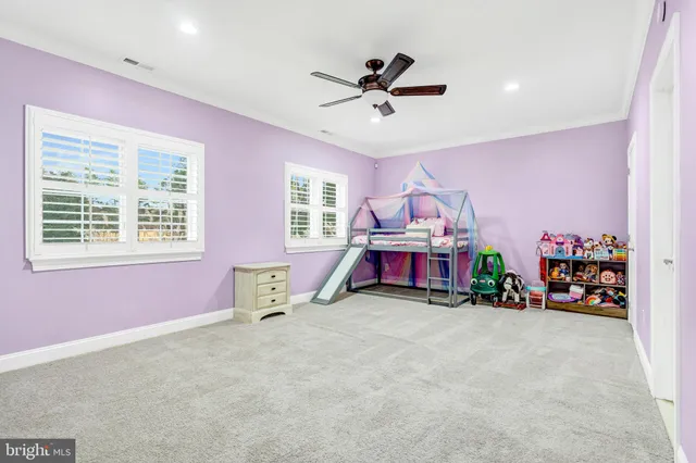 a backyard of a house with a yard and outdoor seating