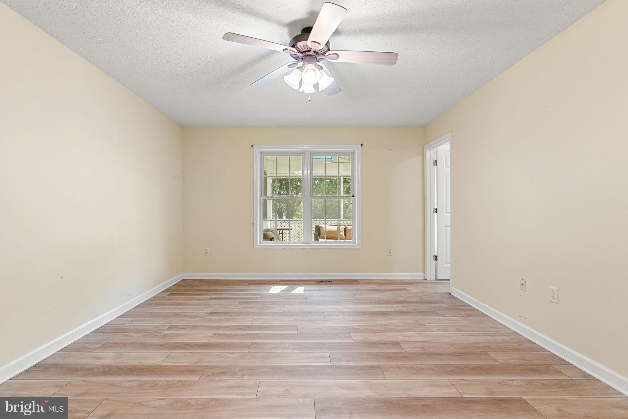 28 Mopsy Court Ranson, WV 25438 - Photo 34 of 59 a view of an empty room with a window and a ceiling fan