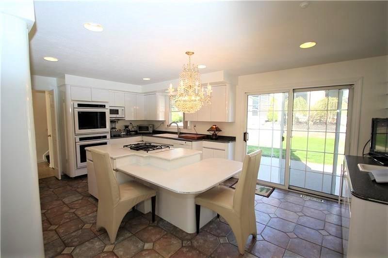 560 Justabout Road Peters Township, PA 15367 - Photo 15 of 25 HUGE 20x15 Gourmet Eat-in Kitchen w/Recessed Lighting, Newer Ceramic Tile Floors (2005), Double Oven, Desk area, Kitchen Island w/ Gas Burners & GORGEOUS Chandelier