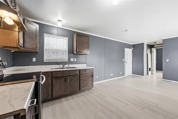 a large kitchen with stainless steel appliances granite countertop a sink and cabinets