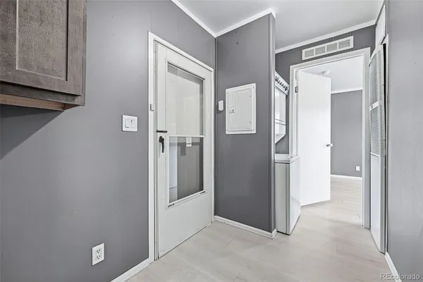 a view of a hallway with wooden cabinets