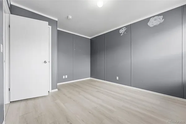 a view of an empty room with wooden floor