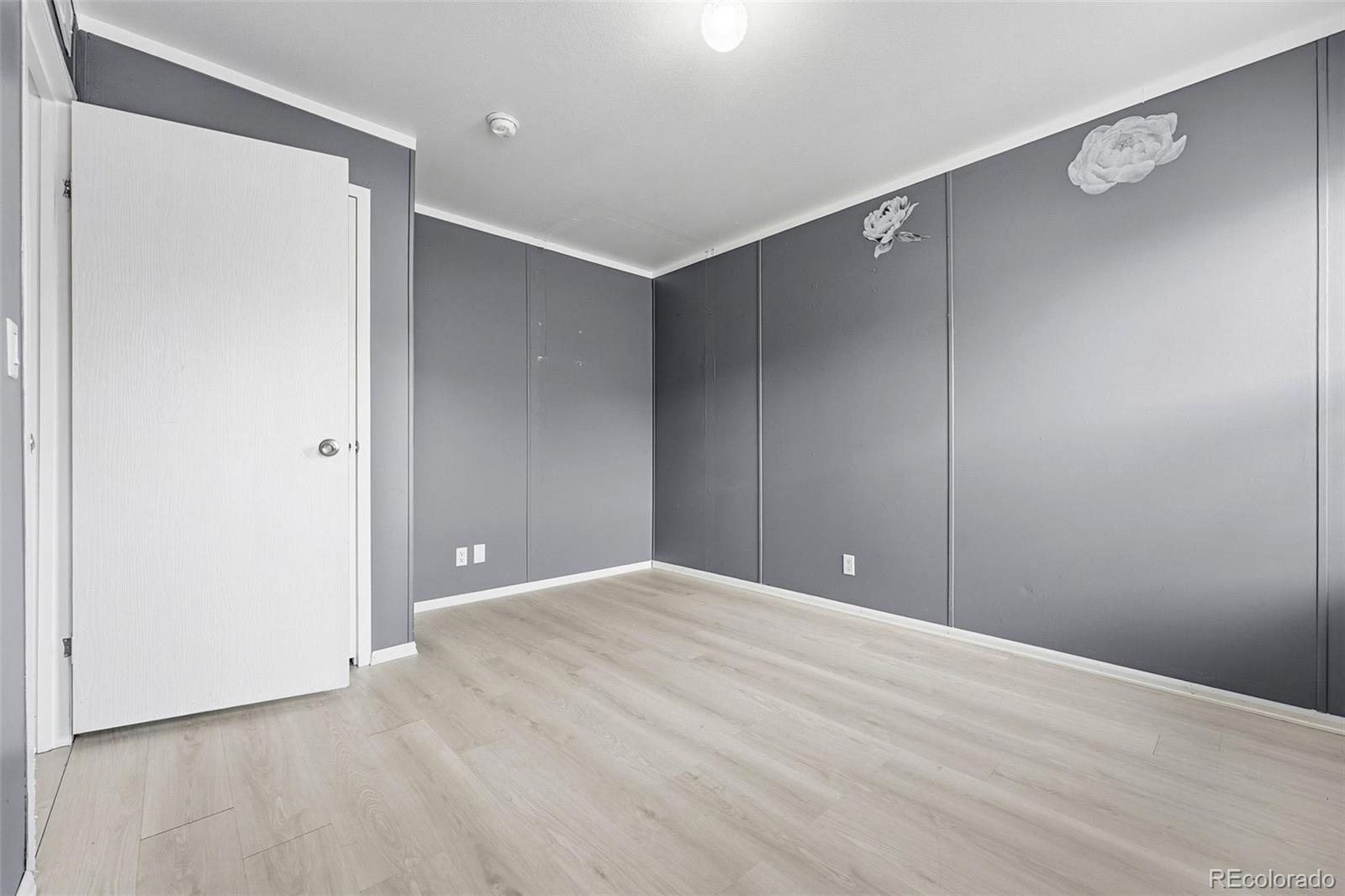 12205 Perry Street, Unit 271 Broomfield, CO 80020 - Photo 19 of 34 a view of an empty room with wooden floor