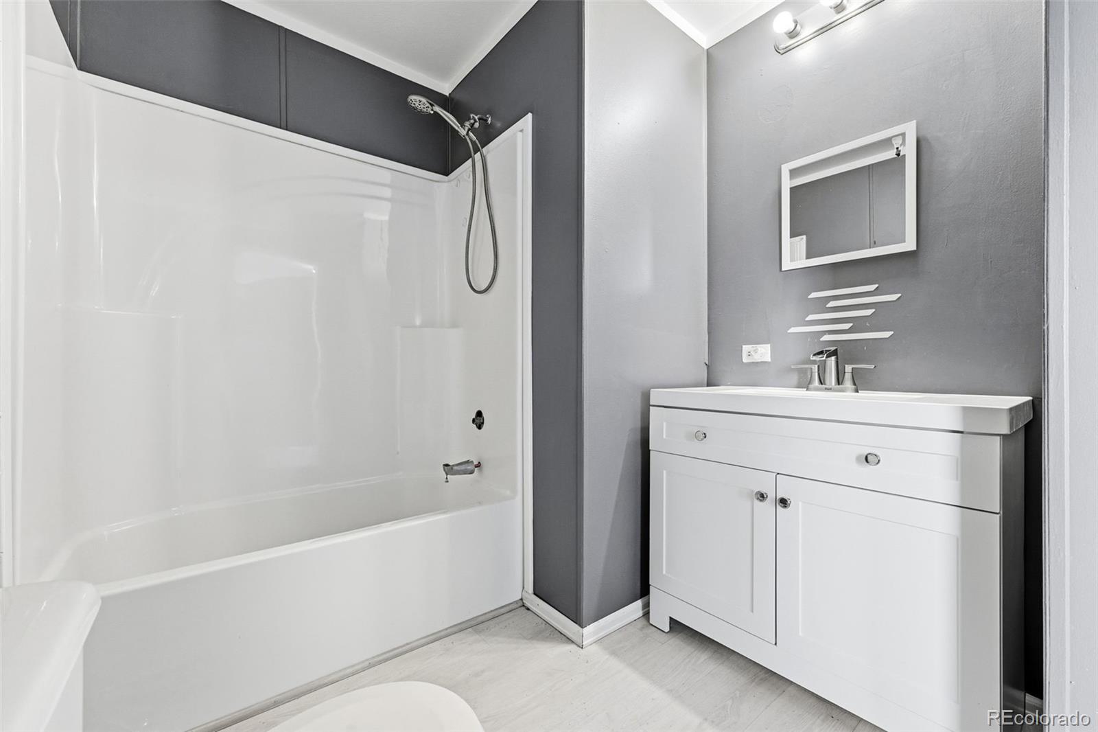 12205 Perry Street, Unit 271 Broomfield, CO 80020 - Photo 20 of 34 a bathroom with a bathtub a mirror a vanity and a sink