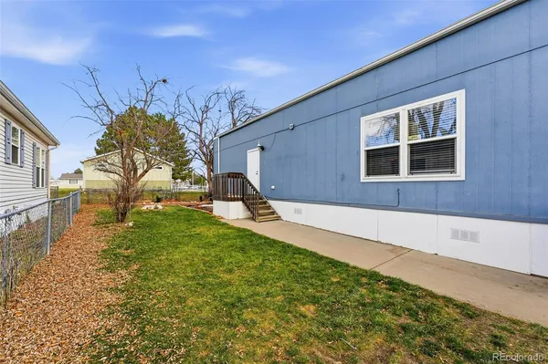 a backyard of a house with garden and deck