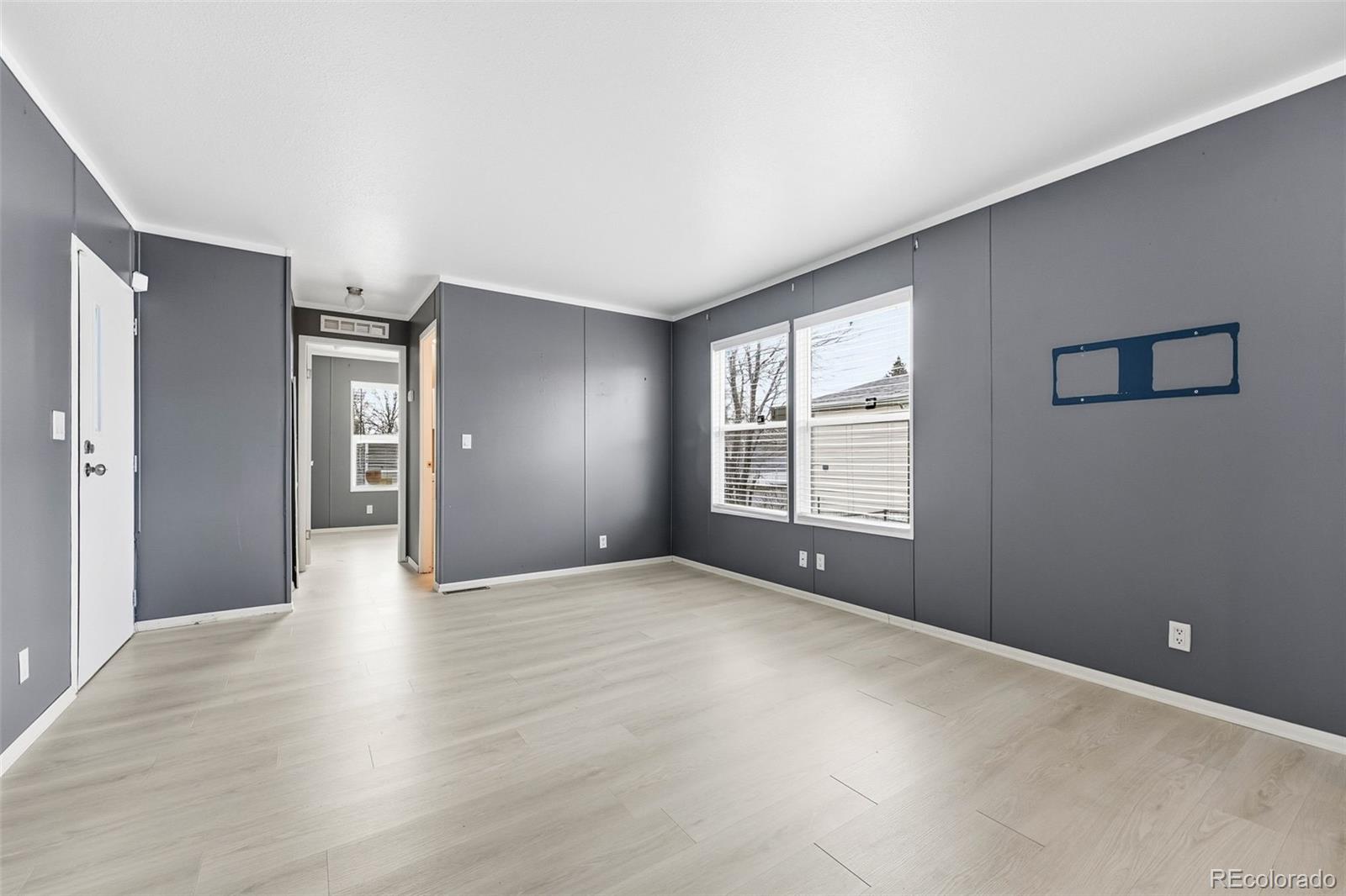 12205 Perry Street, Unit 271 Broomfield, CO 80020 - Photo 7 of 34 a view of an empty room with window and wooden floor