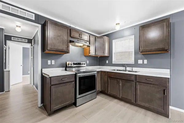 a kitchen with stainless steel appliances granite countertop a sink and a stove