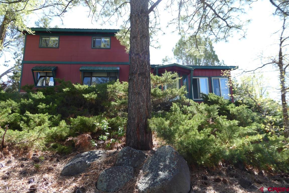 21550 2300th Road Cedaredge, CO 81413 - Photo 1 of 35 a front view of a house with garden