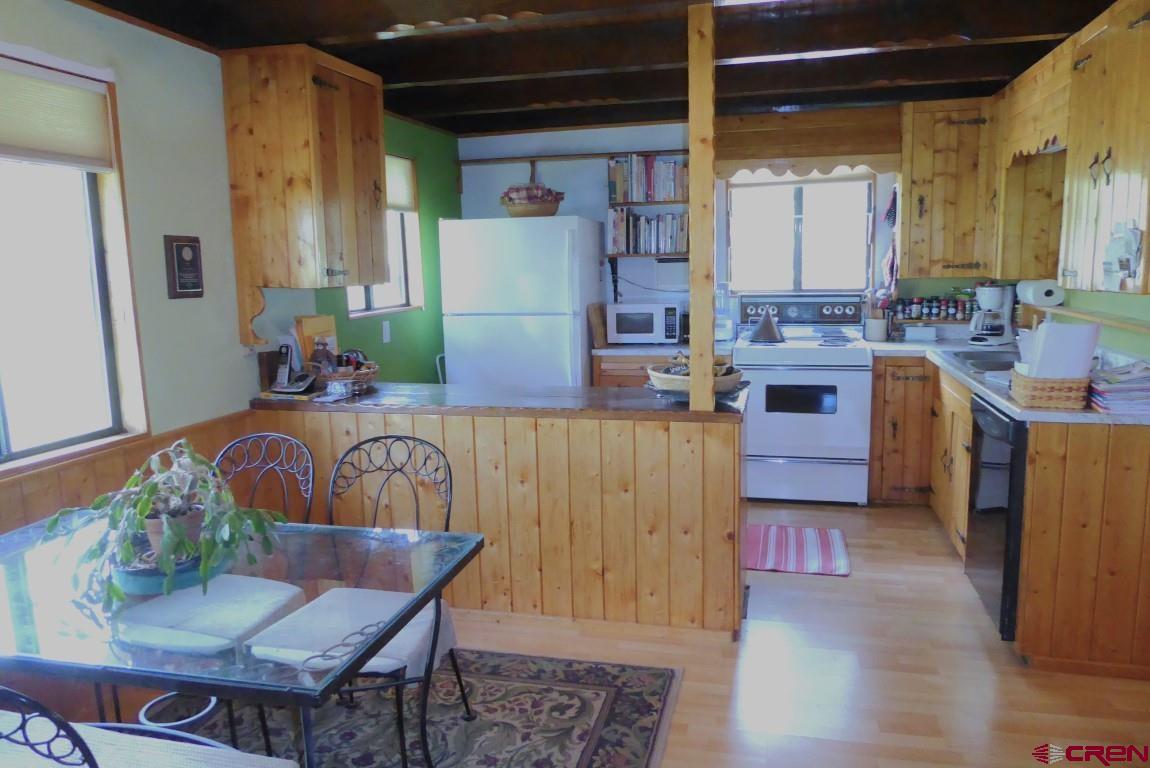 21550 2300th Road Cedaredge, CO 81413 - Photo 11 of 35 a kitchen with furniture a refrigerator and a sink