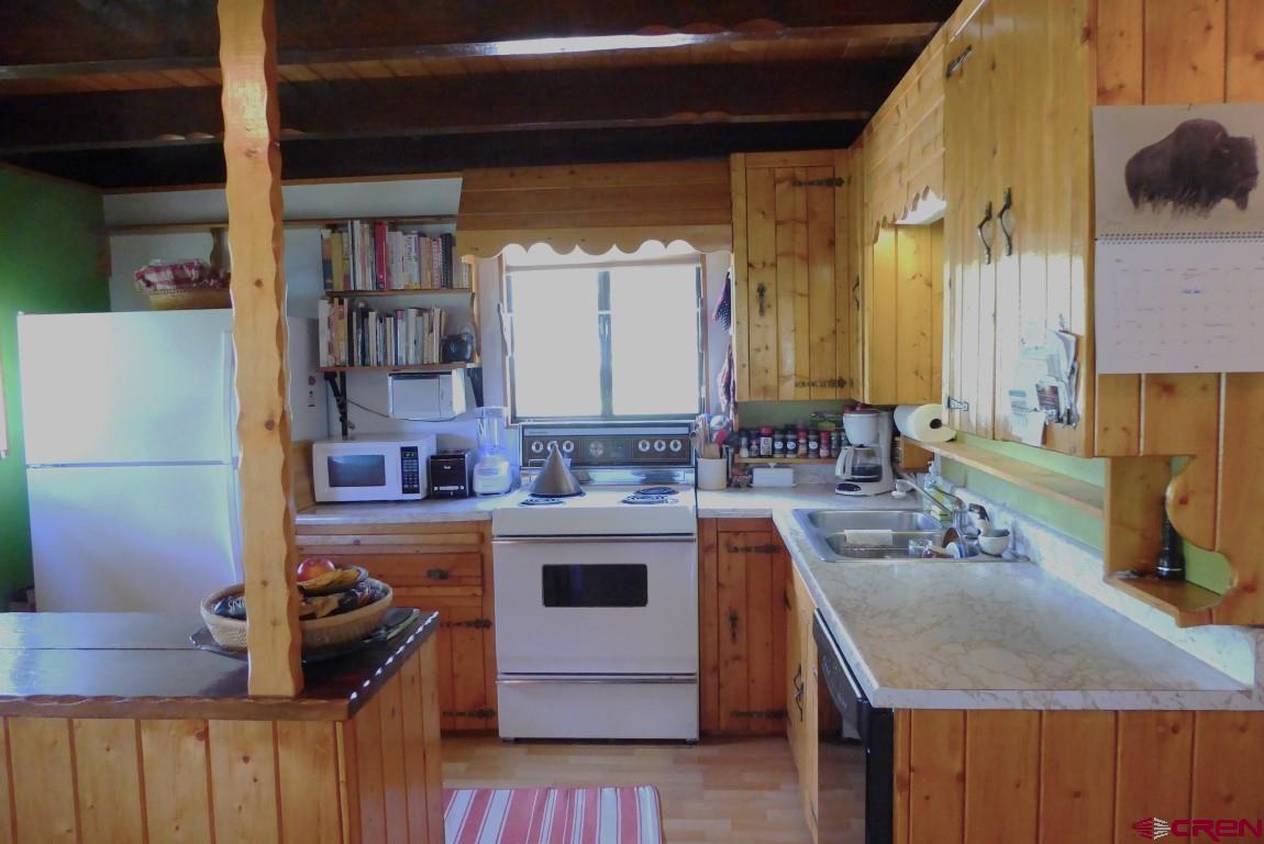 21550 2300th Road Cedaredge, CO 81413 - Photo 12 of 35 a kitchen with a sink and cabinets
