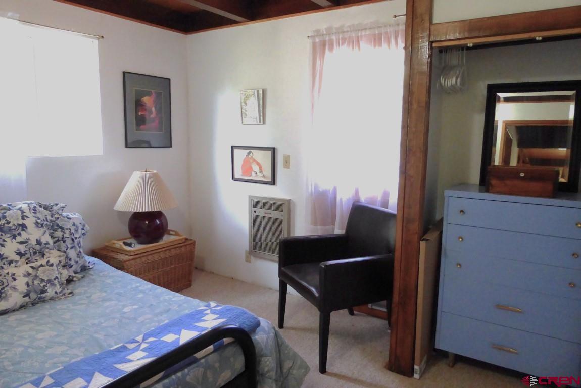 21550 2300th Road Cedaredge, CO 81413 - Photo 15 of 35 a bedroom with a bed and furniture